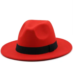 Detailed view of a bright red fedora hat featuring a classic black ribbed ribbon band