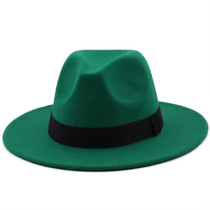 Detail view of the dark green felt fedora hat with a flat brim and black ribbon band