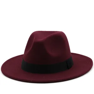 Detail shot of a burgundy fedora hat with flat wide brim and black ribbon band decoration