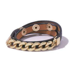 Detail of black pebbled leather wrap bracelet with chunky gold chain and snap buttons