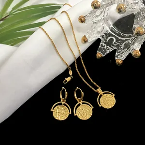 Detail of vintage gold coin necklace and matching hoop earrings with embossed portraits