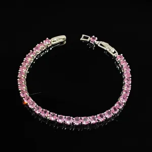 Macro detail of pink zircon tennis bracelet with silver claw setting and secure clasp