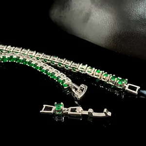 Detailed macro view of 4mm green zircon stones in silver claw chain tennis bracelet