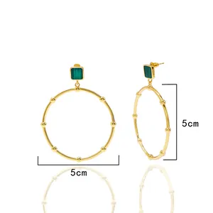 Detail of 5cm gold hoop earrings featuring green malachite stones and beaded texture