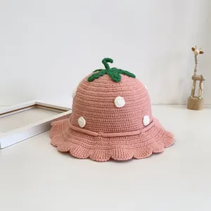 Pink knit strawberry baby sun hat with green leaf top and ruffled brim for toddlers