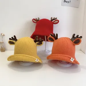 Three children's knit bucket hats in red, yellow and orange with 3D deer antlers detail