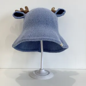 Blue knitted baby bucket hat featuring cute brown reindeer antlers on a white background