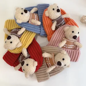 Detail of baby knit hats featuring cute 3D plush bears in six vibrant winter colors