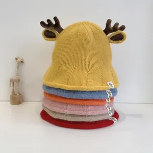 Close-up of knit baby hats with 3D deer antlers and ears in six assorted colors