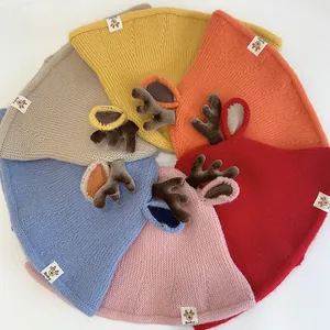 Close-up of knit baby hats with 3D reindeer antlers and ears in diverse colors