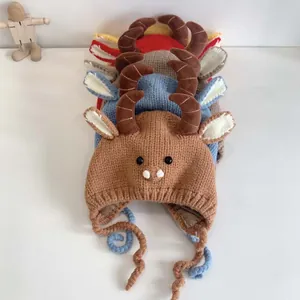 Detail of knitted baby hats with animal horns and ear flaps in various colors