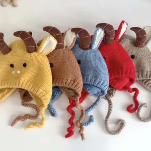 Detailed row of handmade baby knit beanies with cute horns in five vibrant colors