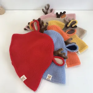 Detail of infant knit beanies with cute deer antlers and baby labels in six soft colors