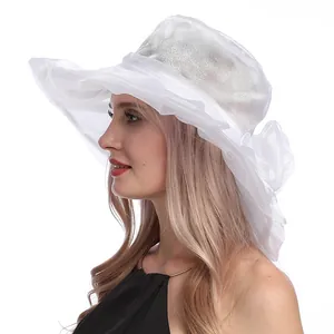 Détail d'un élégant chapeau de soleil en organza blanc avec décoration florale latérale
