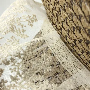 Close-up of exquisite floral embroidery on creamy lace sun hat with fine mesh base