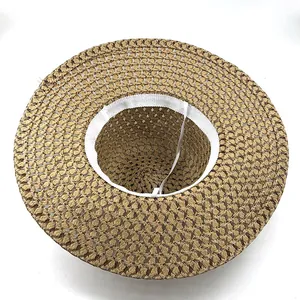 Internal view of wide brim lace straw sun hat with white sweatband and elastic chin strap
