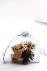 Close-up of light grey organza drawstring gift bag with durable double-line closure