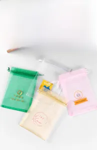 Detailed view of colorful organza drawstring bags with custom gold foil logo printing