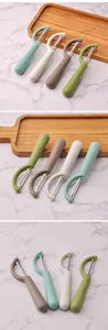 Set of four minimalist stainless steel vegetable peelers in assorted Morandi colors