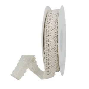 White crochet lace ribbon roll with floral cutouts for wedding gifts and DIY crafts