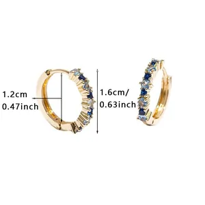 Detail showing 1.2cm inner diameter of gold huggie hoops with blue and white stones