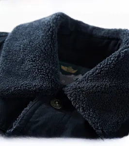 Detail of navy blue winter jacket featuring thickened fleece collar and metal fashion button