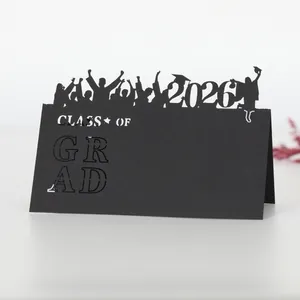Class of 2026 graduation table place card with black hollow silhouettes on white surface