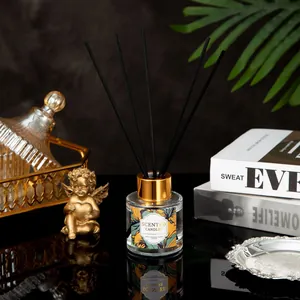 Elegant reed diffuser set with glass bottle, gold cap and black sticks in luxury setting