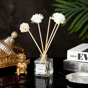 Close-up of reed diffuser with jasmine scent featuring decorative sola flowers and vine ball
