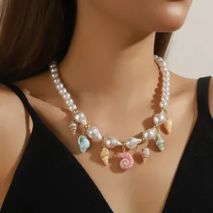 Close-up of ocean-style beaded necklace with pearl beads and colorful shell pendants