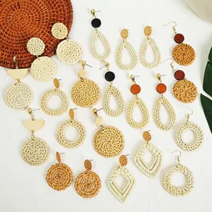 Selection of handmade bohemian woven straw earrings in geometric wooden designs