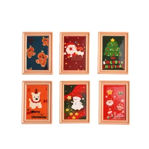 Set of 6 Christmas themed mini photo frames with gingerbread man and santa claus resin decor