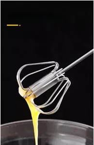 Close-up of 10-wire stainless steel whisk head with egg liquid on black background