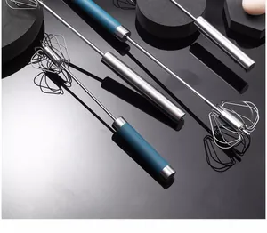 Detail of blue and silver semi-automatic stainless steel whisk on a professional kitchen surface