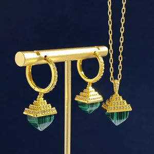 Detail of gold-plated jewelry set with green malachite pyramid pendants and tiny crystals