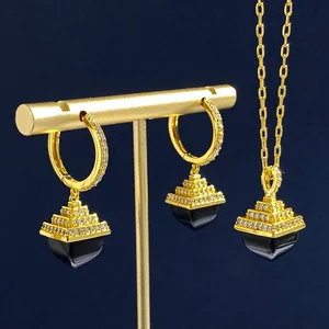 Detail view of gold pyramid jewelry set with black onyx and sparkling zircon crystals