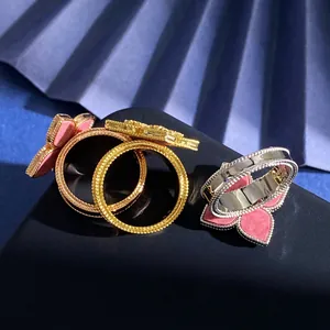 Detailed macro view of three diamond-set flower rings with vintage beaded edges