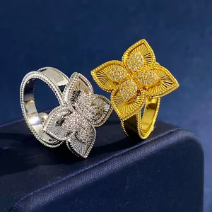 Luxe rhombic four-leaf flower rings with radiant texture and diamonds in gold and silver