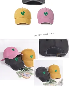 Detail of clover embroidery on washed cotton baseball cap with adjustable metal buckle