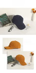Detail of navy and yellow cotton baseball caps with metallic buckles and soft crowns