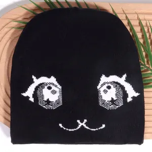 Cute black jacquard knit beanie with cartoon cat eyes expression for winter warmth