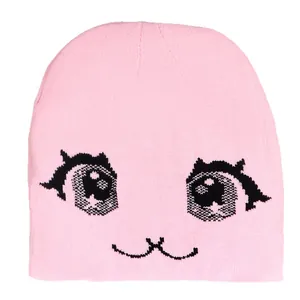 Pink knit beanie with anime eyes jacquard pattern for women in minimalist style
