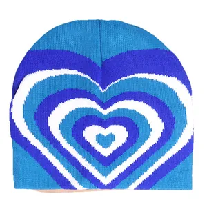 Knitted beanie hat with a blue and white layered heart gradient pattern for winter fashion