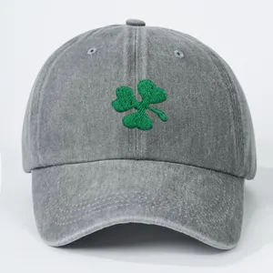 Classic grey cotton baseball cap featuring green clover embroidery on a white background