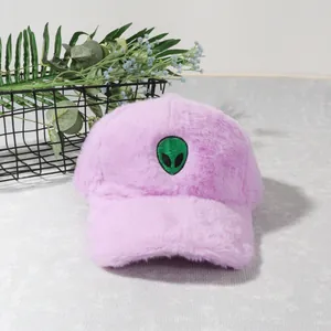 Detailed close-up of purple plush baseball cap featuring a green alien head embroidery