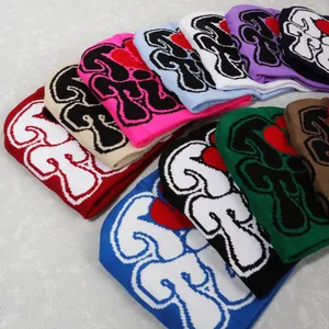 Y2K knitted beanies in various colors with bold heart patterns and black outlines