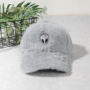 Close-up of grey plush baseball cap with soft faux fur texture and alien embroidery