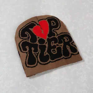 Detail of Top Tier lettering and red broken heart knitting on the brown Y2K beanie