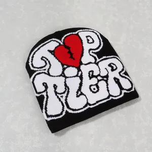 Detail of Top Tier typography and red broken heart embroidery on black knit beanie