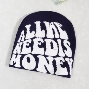 Detail of navy knit beanie featuring white All We Need Is Honey jacquard text design
